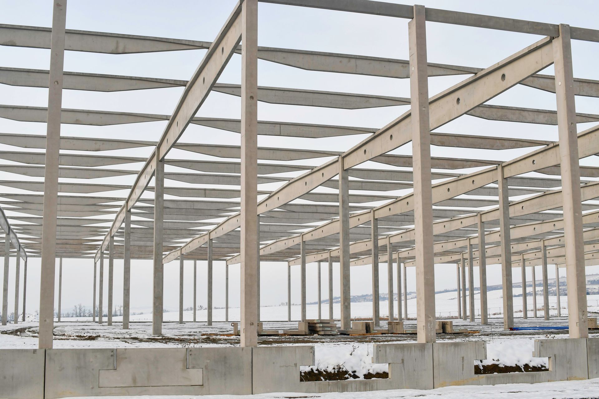 A large building under construction with snow on the ground