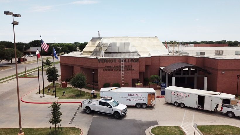Two Vans Parked in Front of Vernon College — Burkburnett, TX — Bradley Foam Roofing