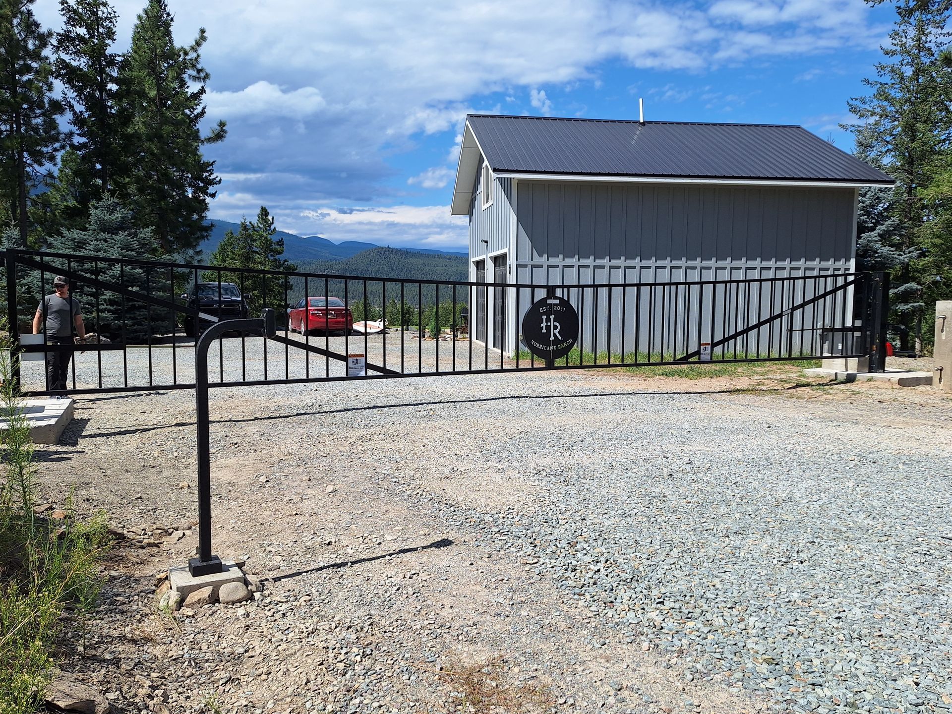 A mailbox is sitting on the side of a road in the woods.