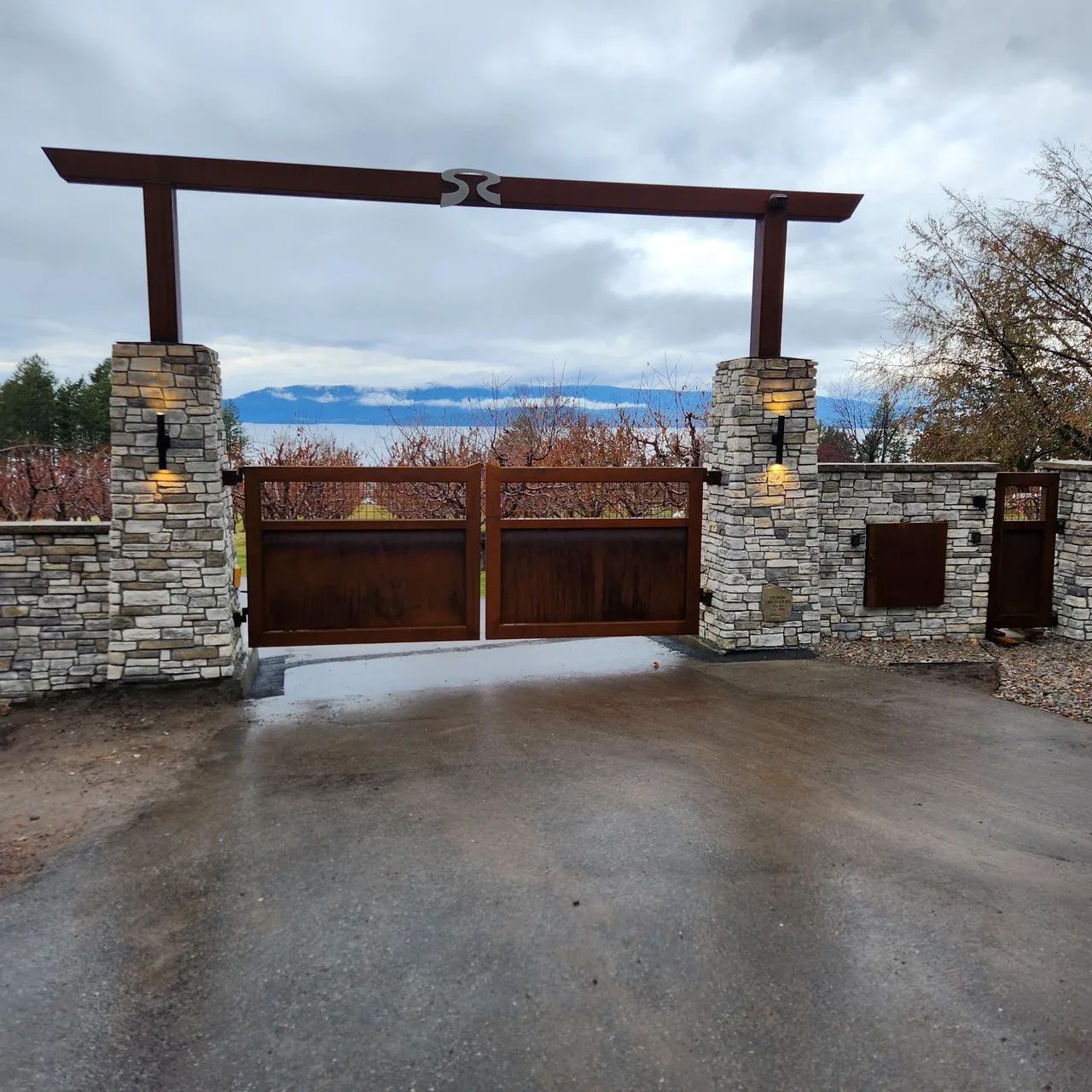 A stone wall with a wooden gate in the middle