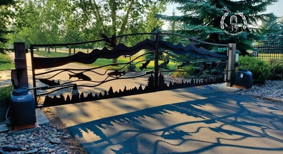 A metal gate with a silhouette of trees on it