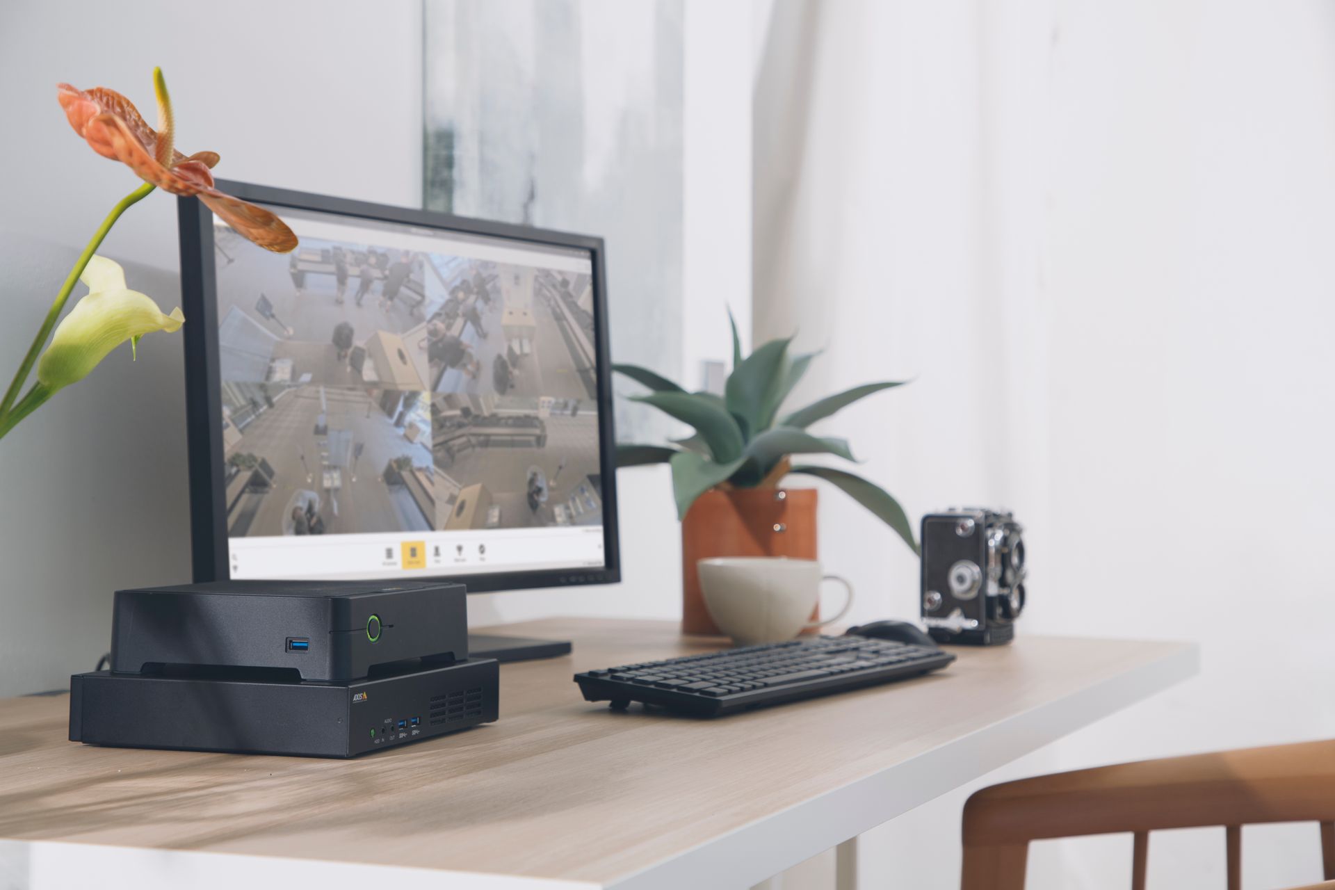 A lake surrounded by mountains and trees on a sunny day