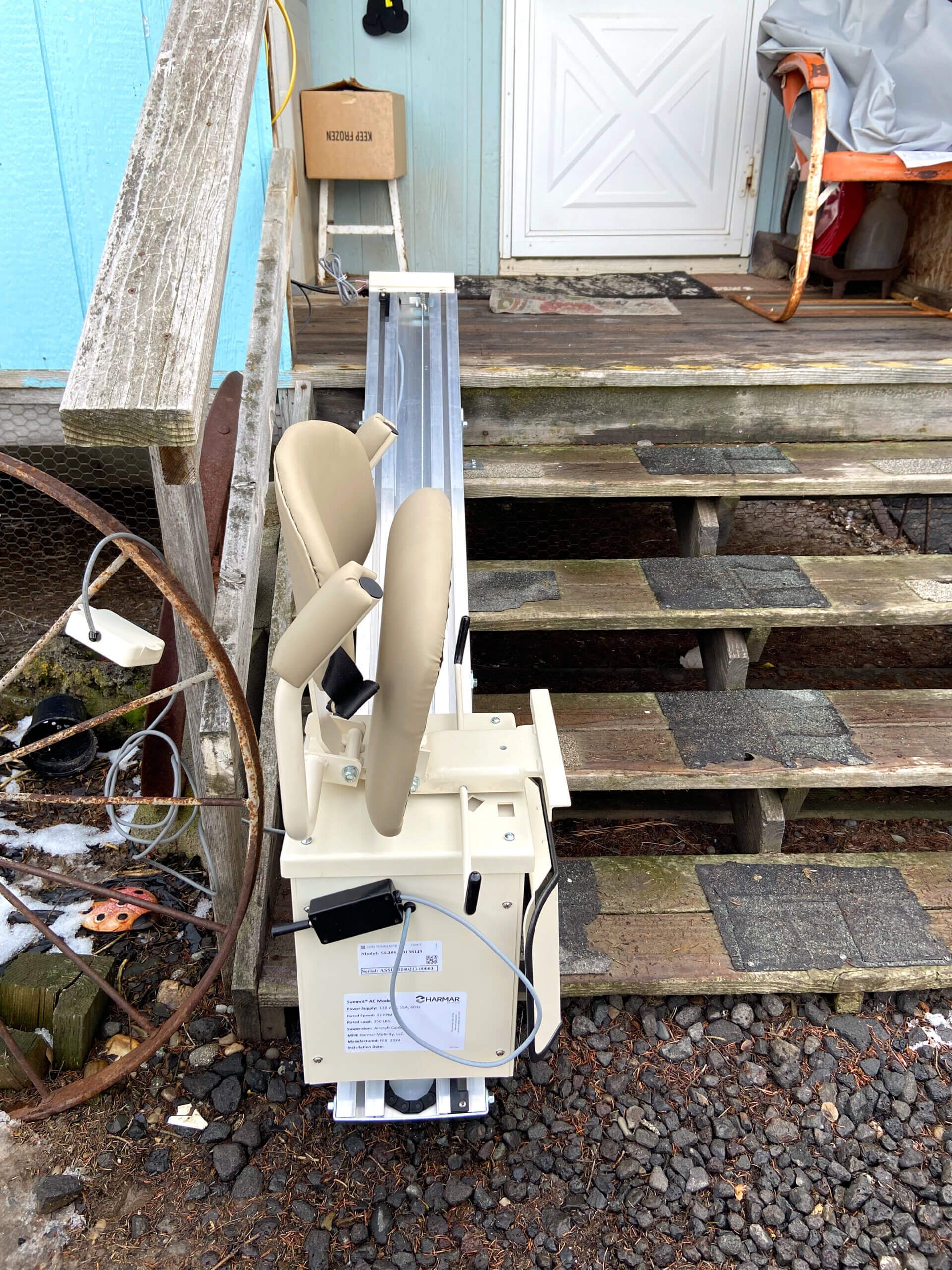A chair is sitting on a set of stairs outside of a house