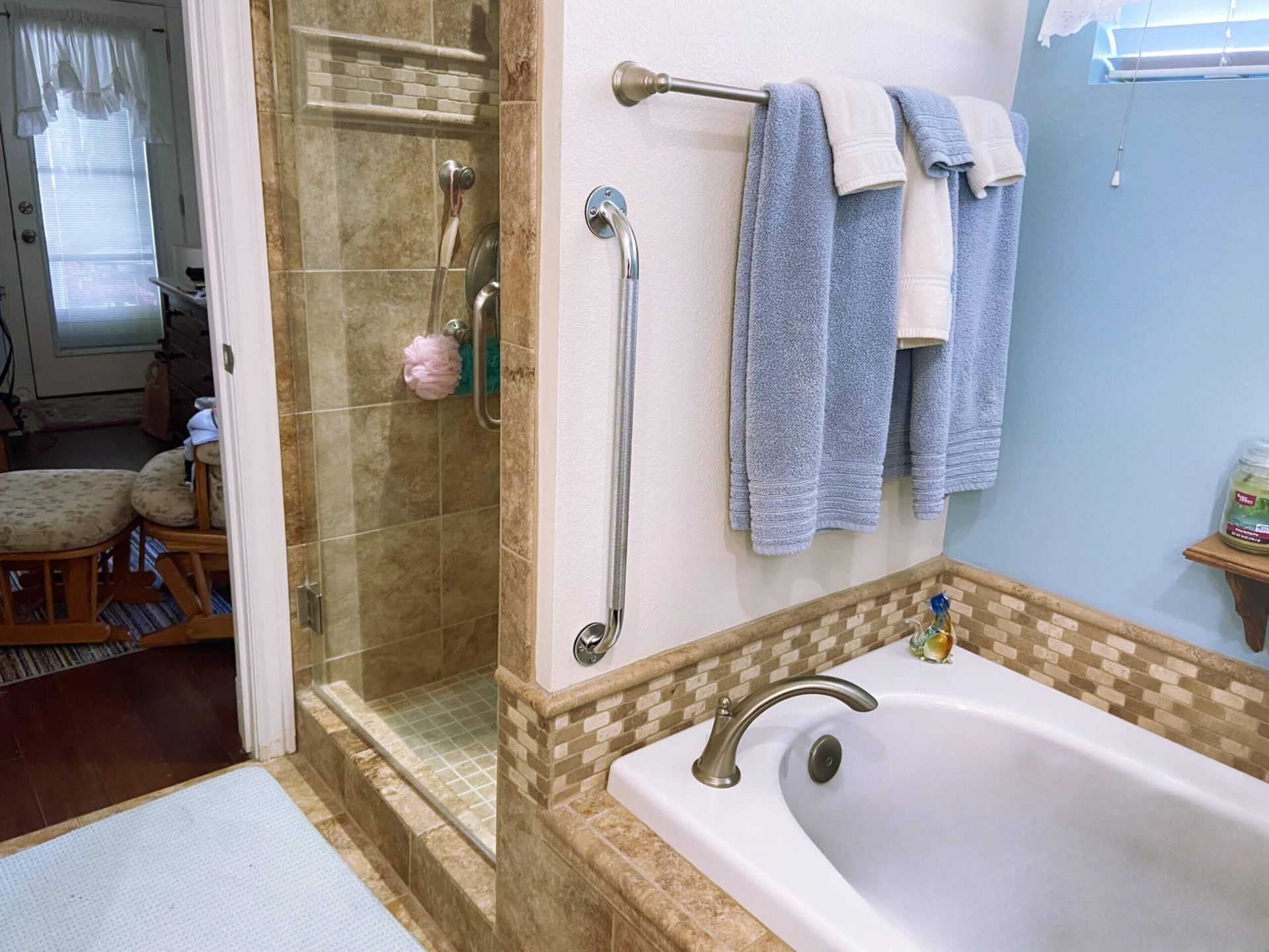 A bathroom with a bathtub and a walk in shower
