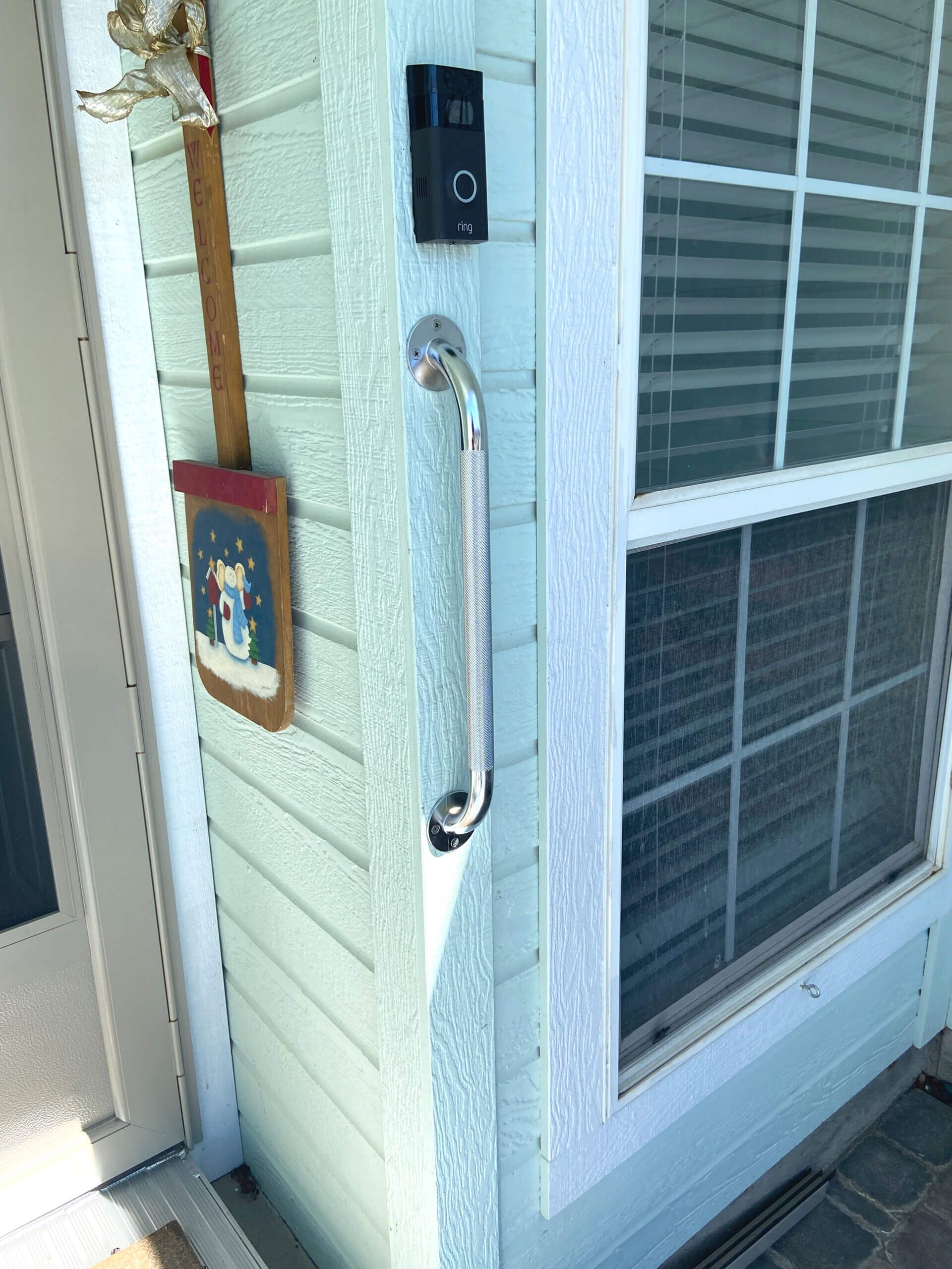 There is a door handle on the side of a house.