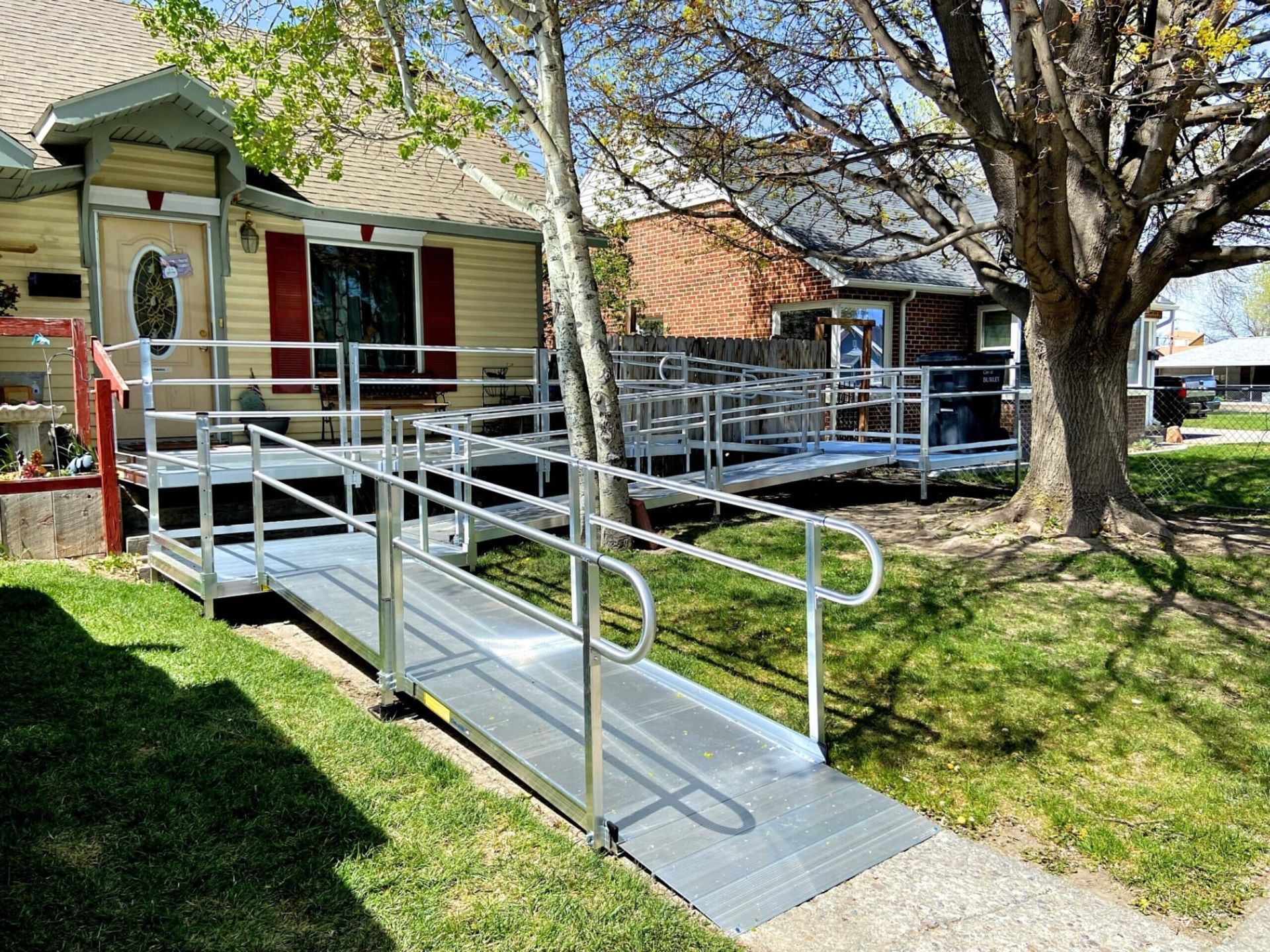 A handicapped ramp is leading to a house.