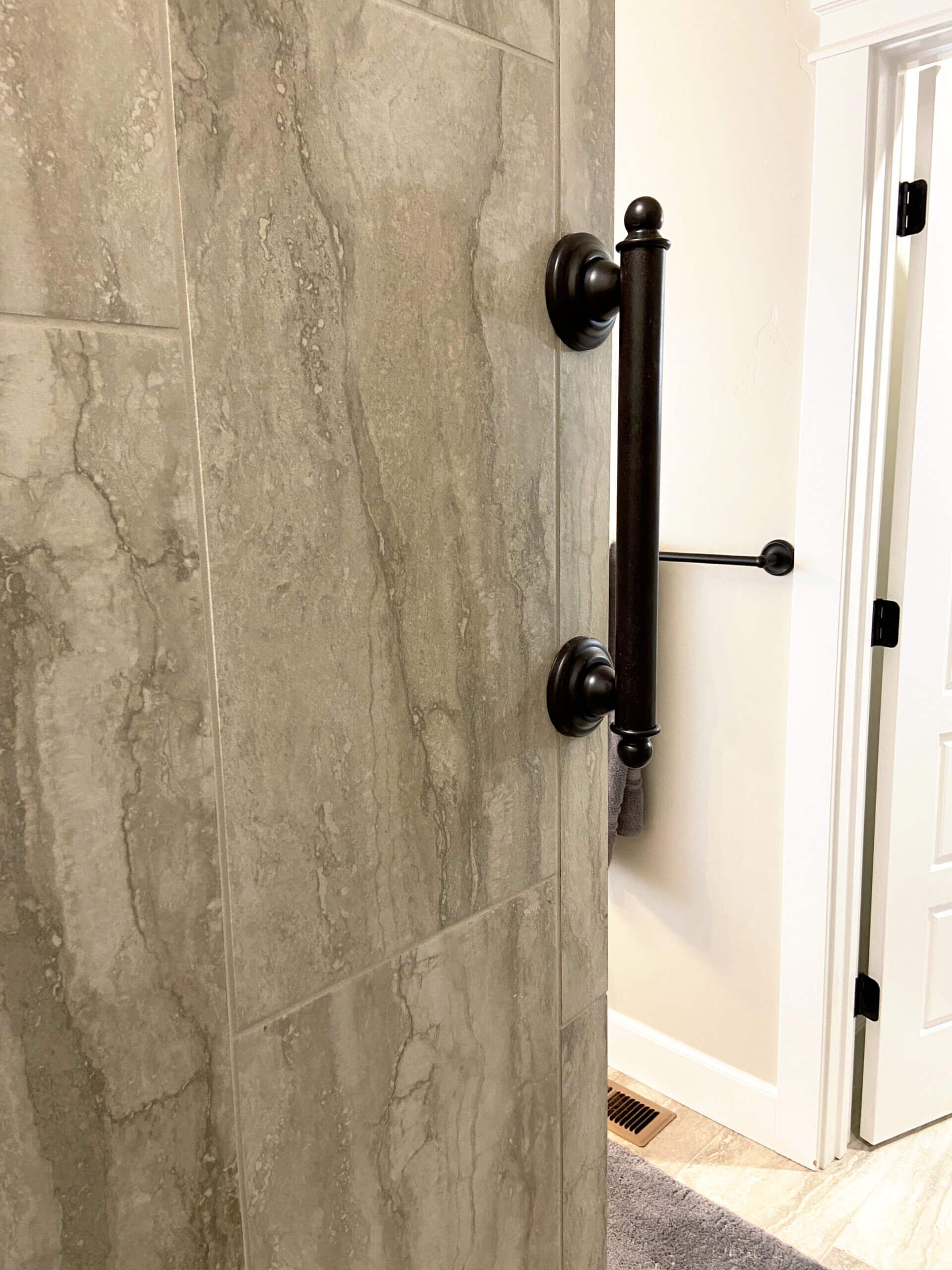 A close up of a door with a handle on it in a bathroom.