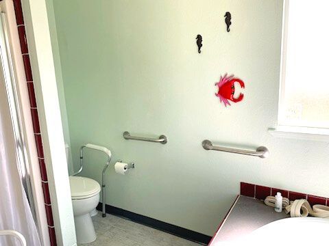 A bathroom with a toilet , sink , and shower.