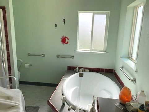 A bathroom with a large tub and a window