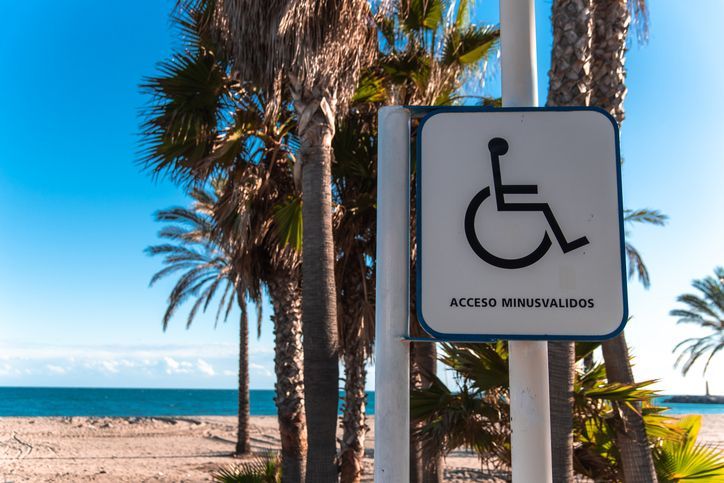 Handicapped access sign on a beach, under the sun. Handicapped access sign on a beach, under the sun.