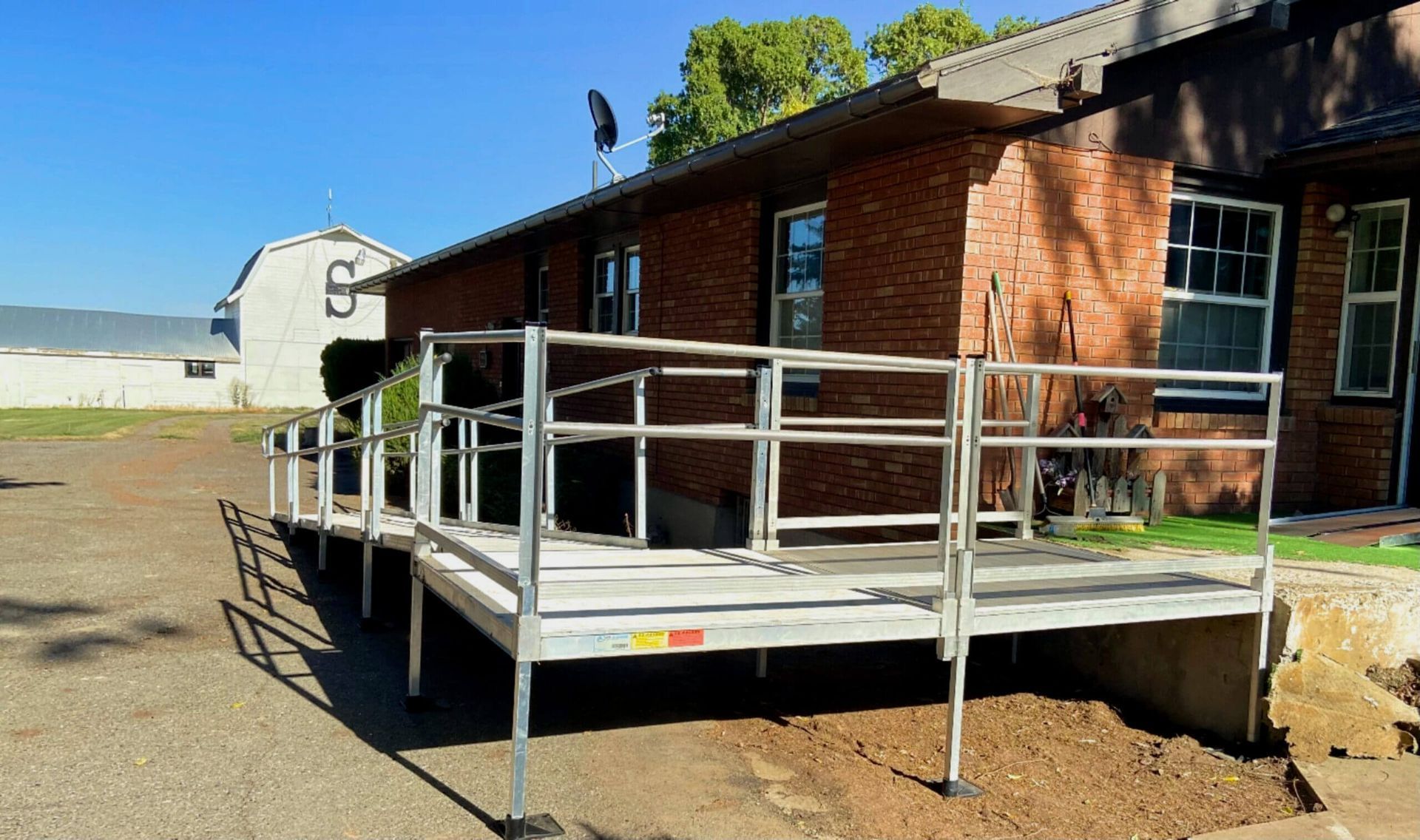 A ramp is sitting in front of a brick house.