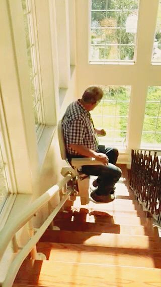 A man is sitting in a chair on a set of stairs.