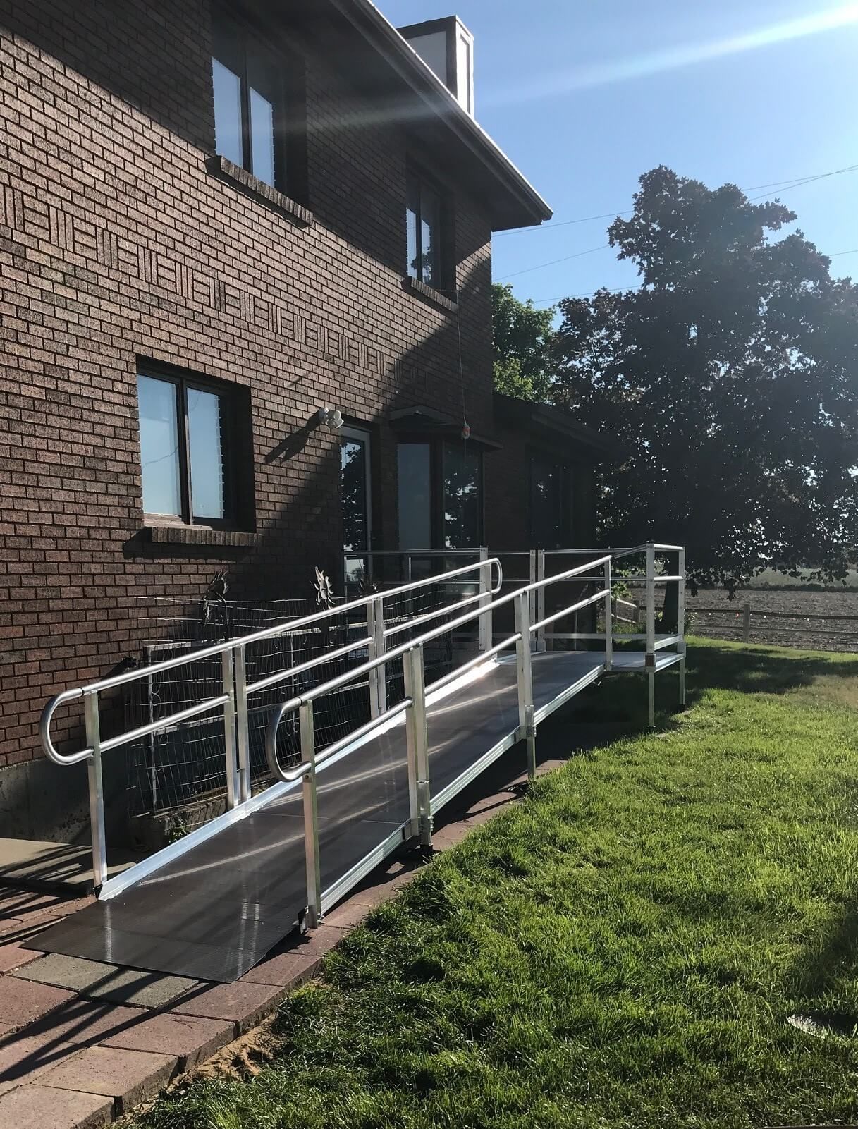 A wheelchair ramp is in front of a brick building