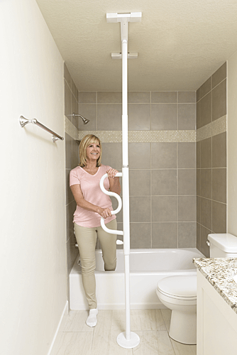 A woman is standing in a bathroom next to a bathtub and toilet.