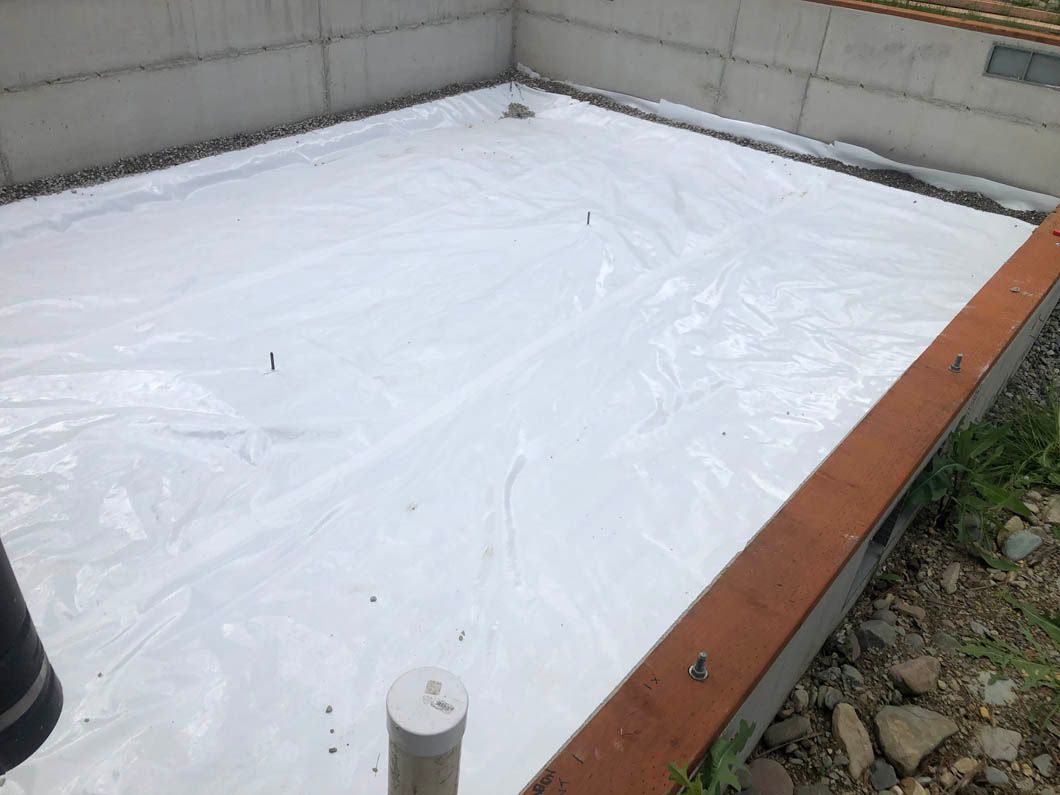 A White Tarp is Covering a Concrete Floor