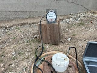 A Clock is Sitting on Top of a Wooden Block