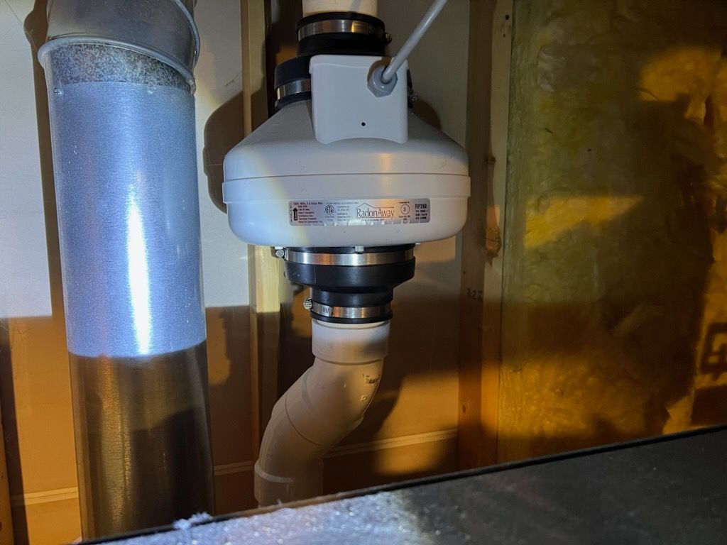 A White Pipe With a Hose Attached to It