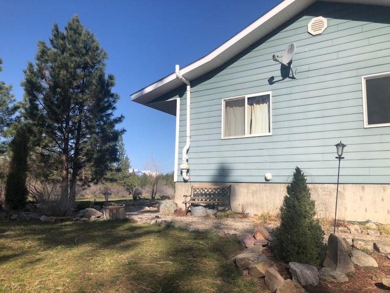 A Blue House With a Satellite Dish on the Side