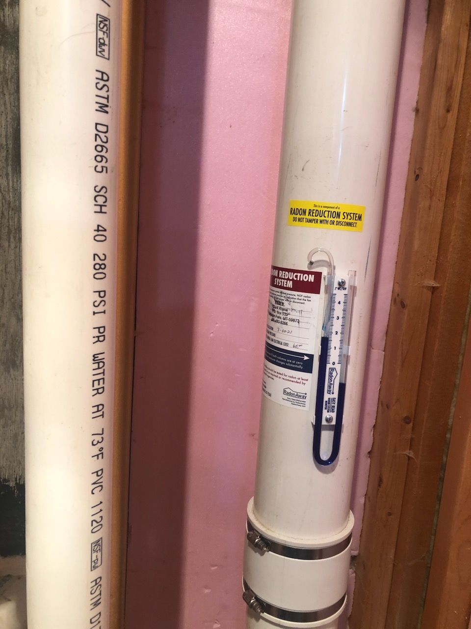 A White Pipe With a Thermometer Attached to It