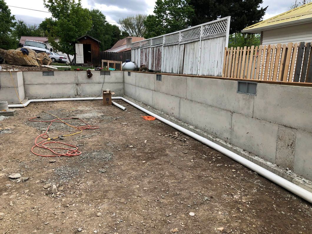 A Concrete Wall is Being Built in the Backyard of a House