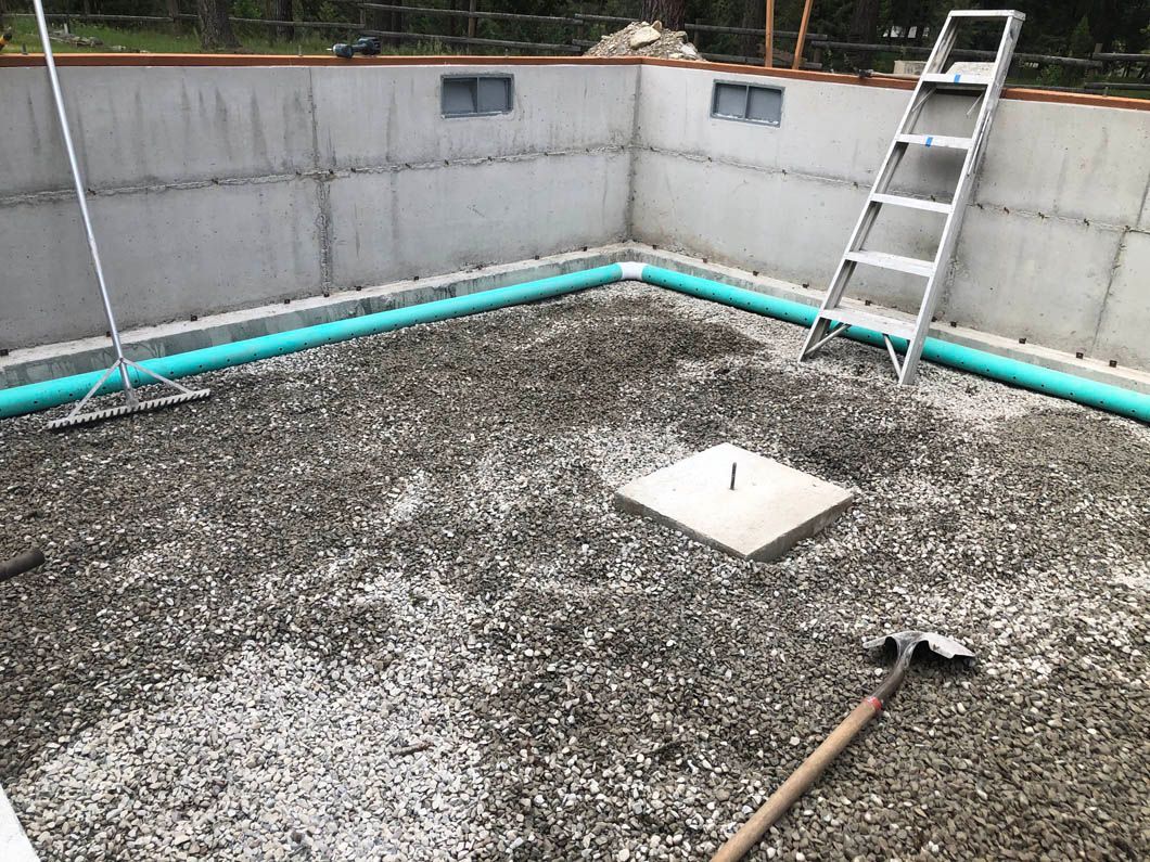 A Concrete Floor With a Ladder and a Shovel on It
