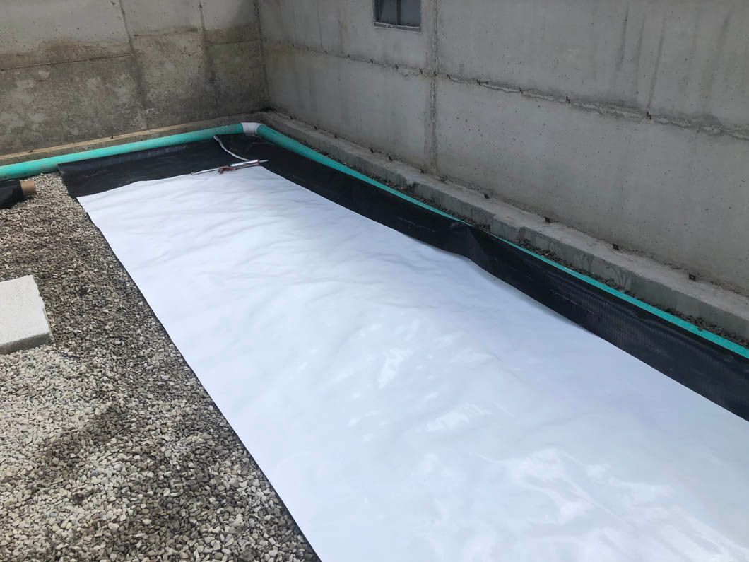 A White Sheet of Paper is Laying on the Ground Next to a Wall