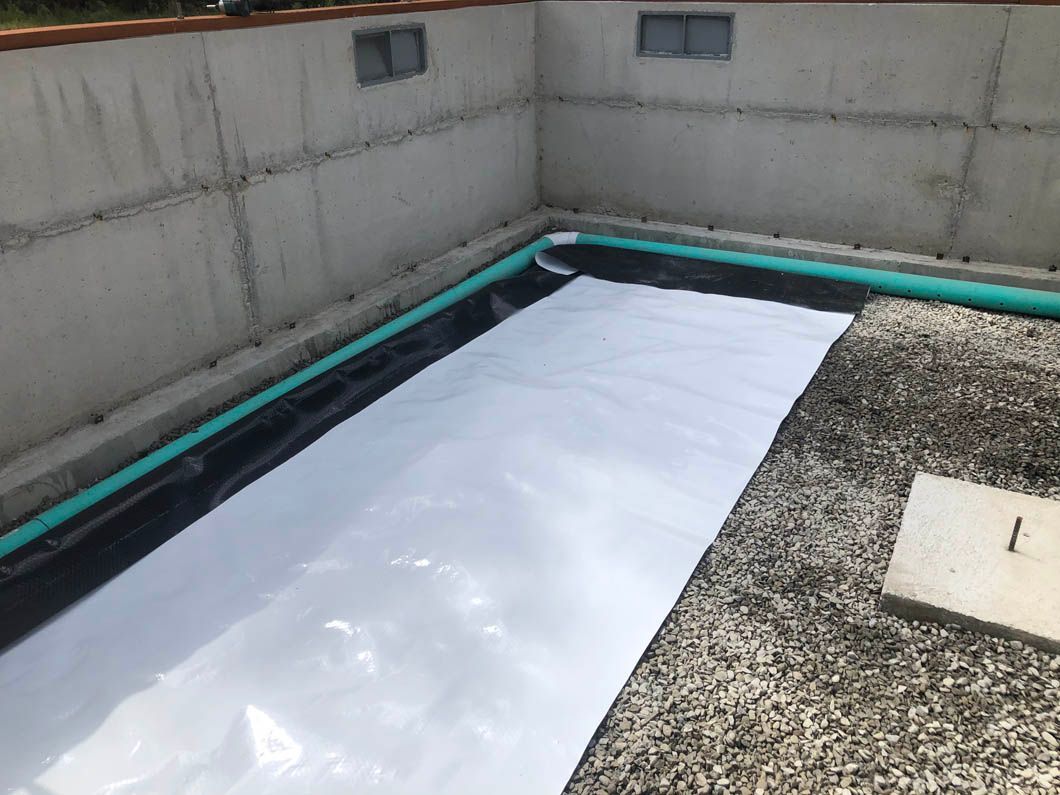 A White Sheet of Plastic is Sitting on Top of a Concrete Floor