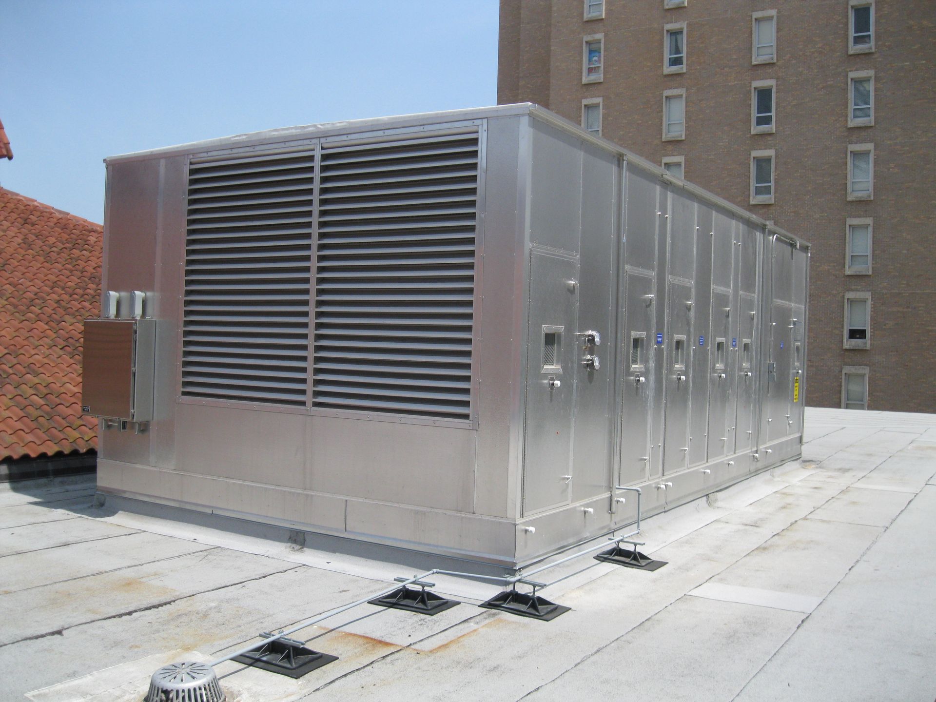 Two air conditioners are sitting on the side of a house - Houston, TX - Ramsey & Company Manufacturer’s Representatives