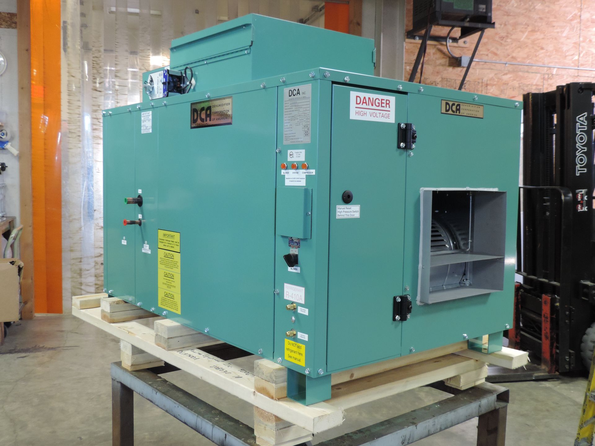A white air conditioner is sitting on the side of a building - Houston, TX - Ramsey & Company Manufacturer’s Representatives
