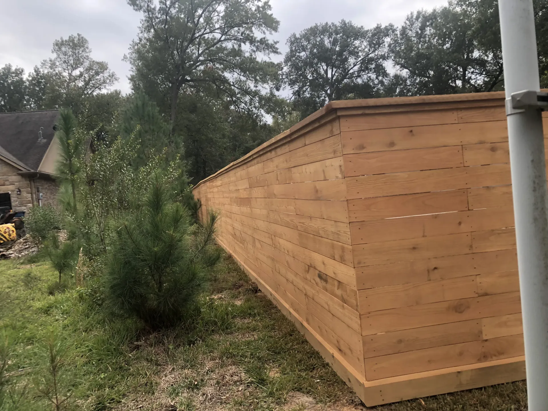 New cedar fence installation in Texas backyard