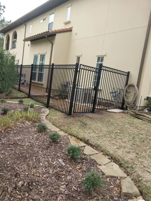 Metal fence with gate by Ark Fence