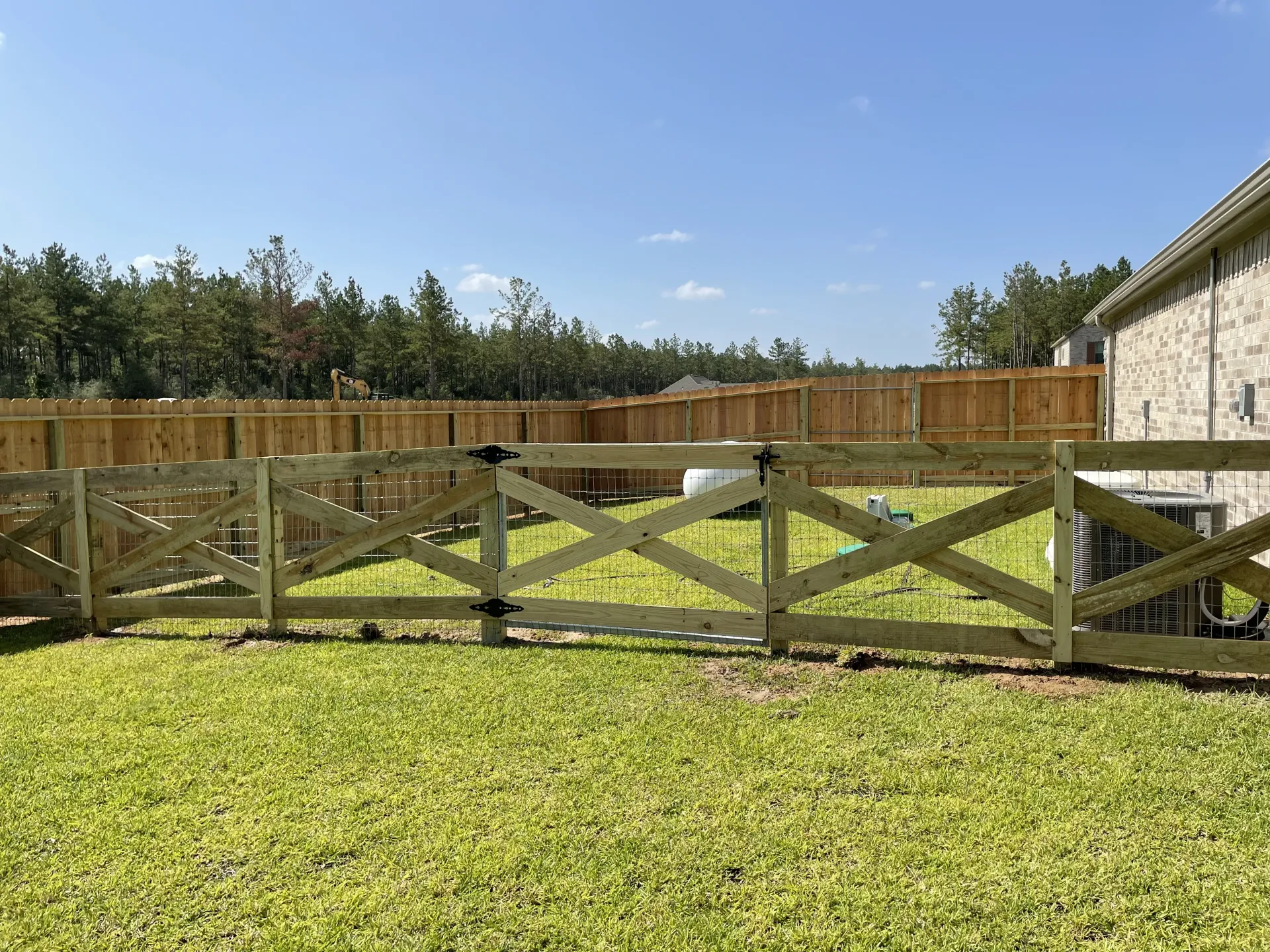 Metal gate installation by Ark Fence
