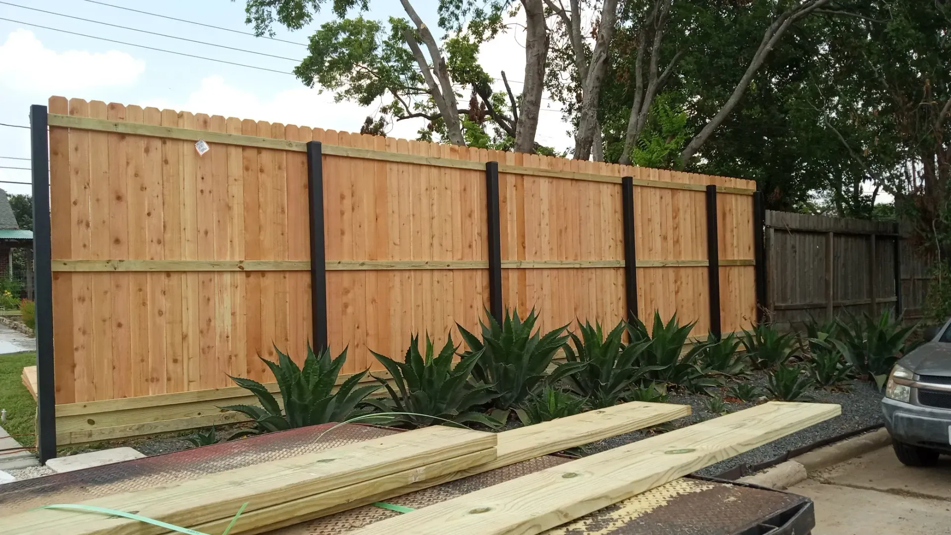 Wood fence installation by Ark Fence in Texas residential backyard
