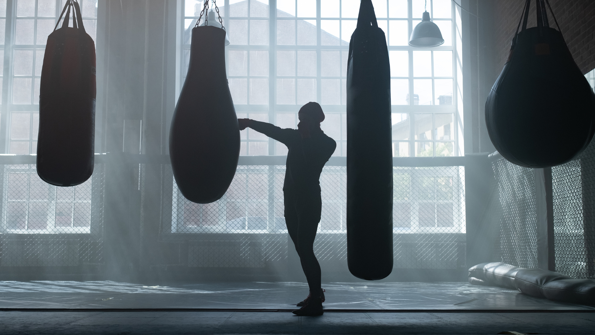 Two men are boxing in a gym.