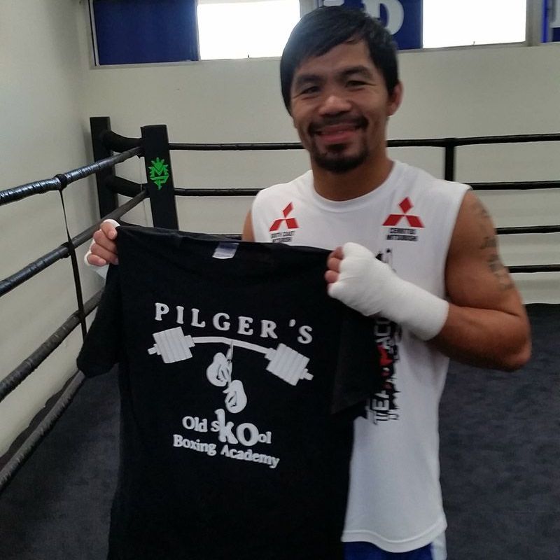 8 Division World Super Star Champion Manny Pacquiao holding a Pilgers Old Skool Boxing & FItness Academy t-shirt