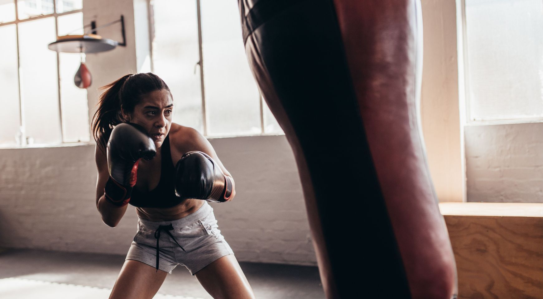 Two men are boxing in a gym.