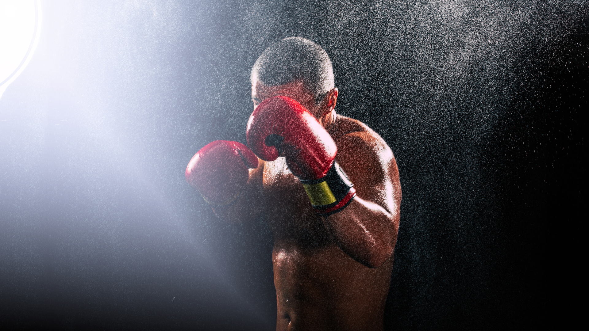 Two men are boxing in a gym.