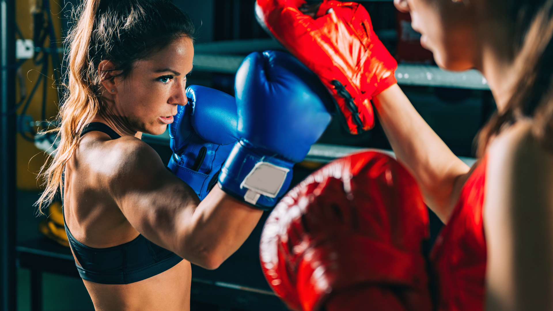 Two women are boxing in a boxing ring.