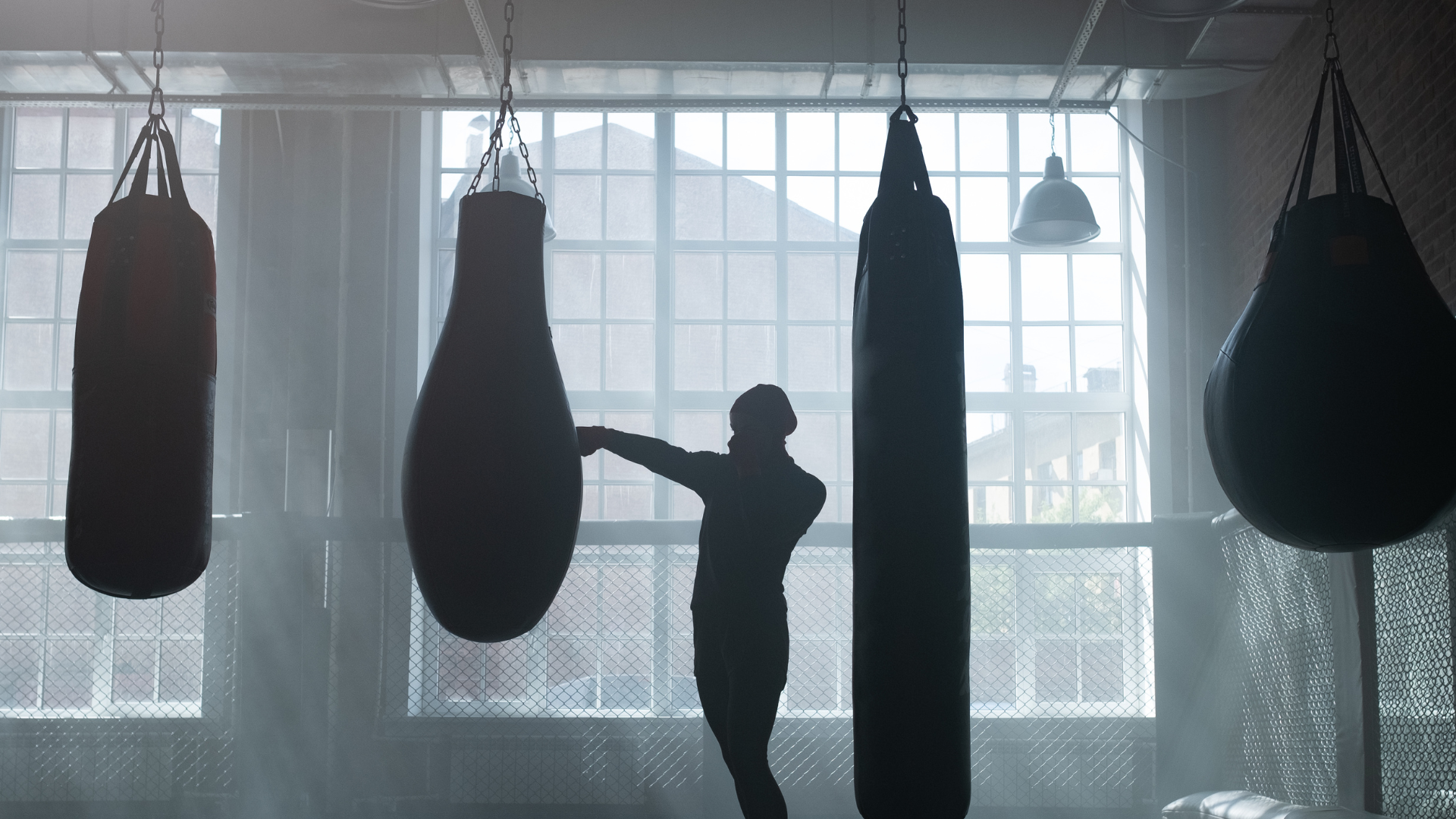 A boxer training using a punching bag.