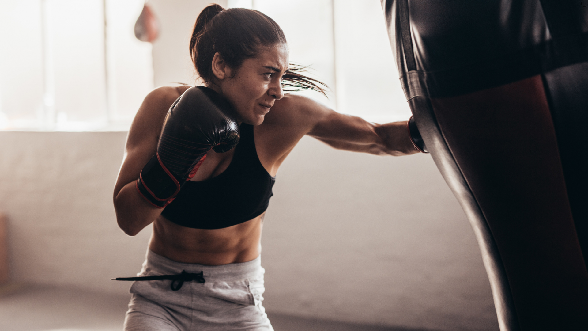 A Boxer training hard using a punching bag