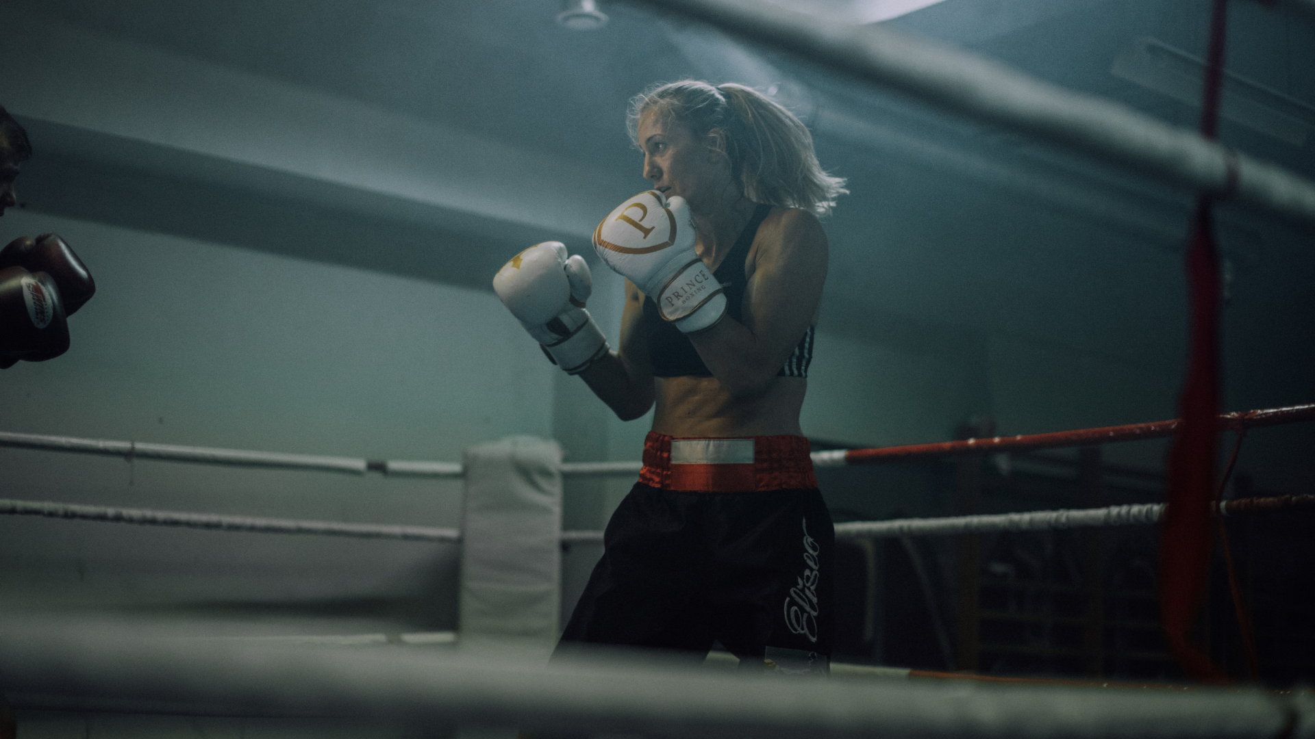 A woman is boxing in a boxing ring.