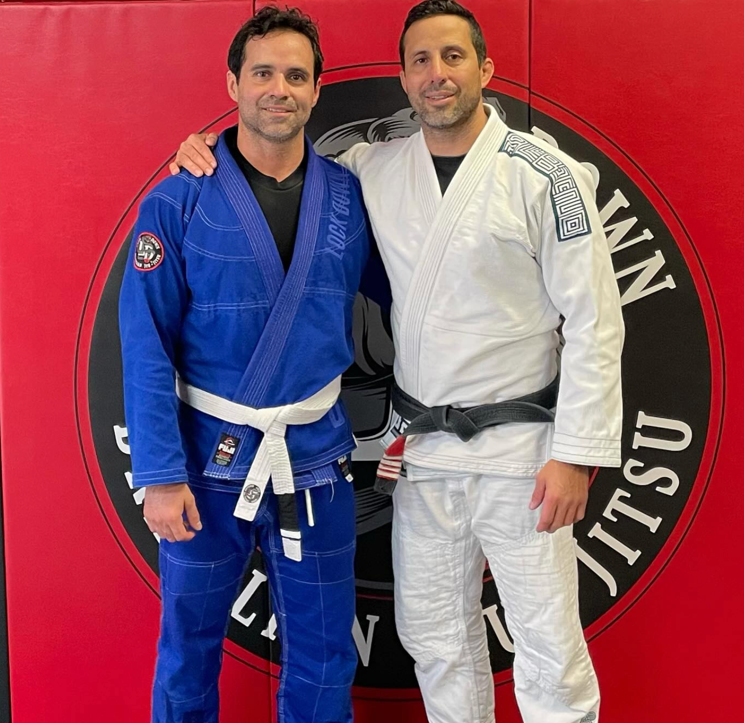 Adults practicing Brazilian Jiu-Jitsu drills at Lockdown BJJ in Lake Ronkonkoma, NY for fitness .