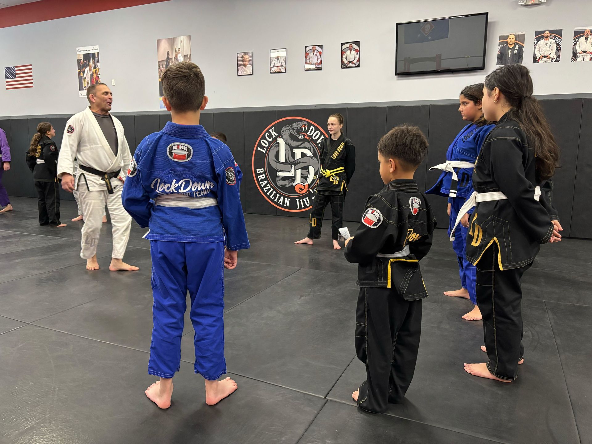 Kids and adults training brazilian jiu jitsu at Lockdown BJJ in Lake Ronkonkoma, NY to build fitness