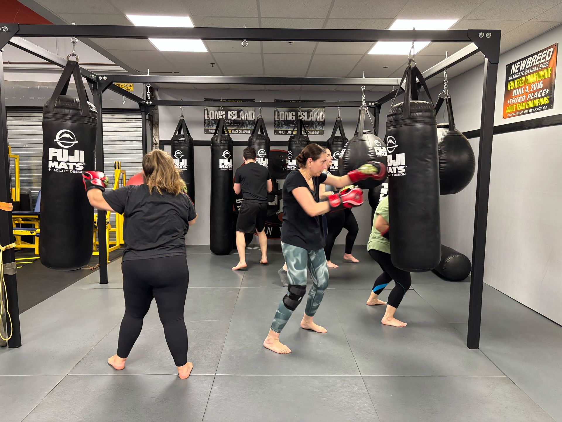 Adults training Brazilian jiu jitsu at Lockdown BJJ in Lake Ronkonkoma, NY to build fitness.