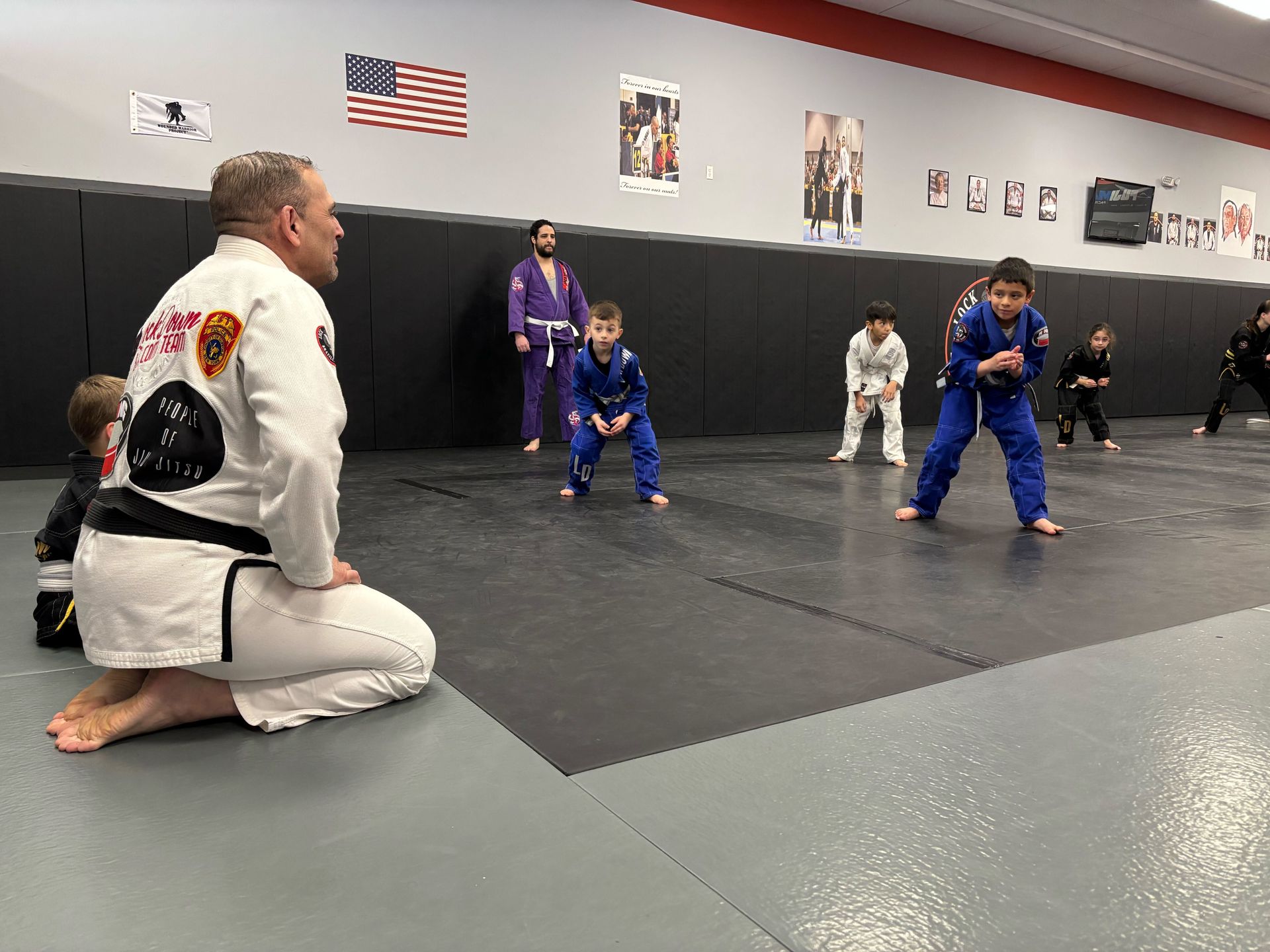 Adults training Brazilian jiu jitsu at Lockdown BJJ in Lake Ronkonkoma, NY, building fitness.