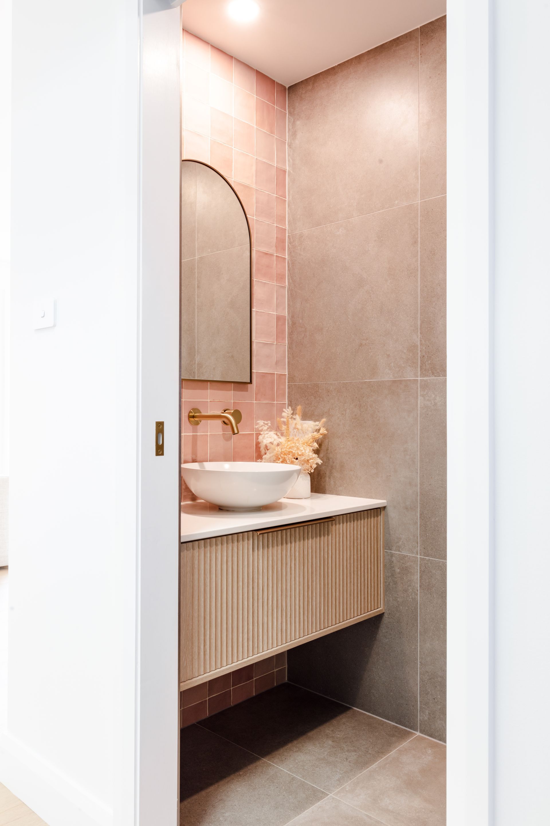 Pink Tiled Bathroom with Wooden Cabinets — Joinery in Taree, NSW