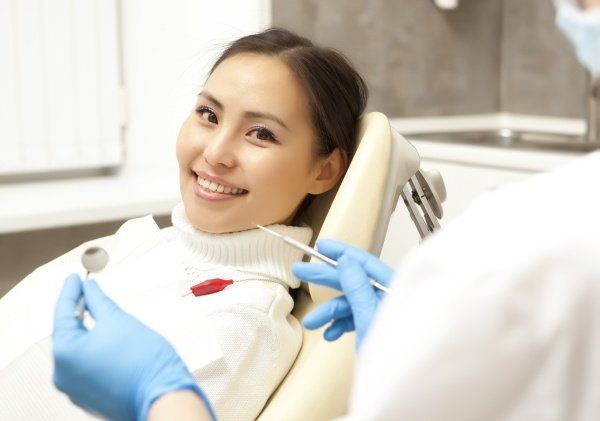 women in dentist chair smiling
