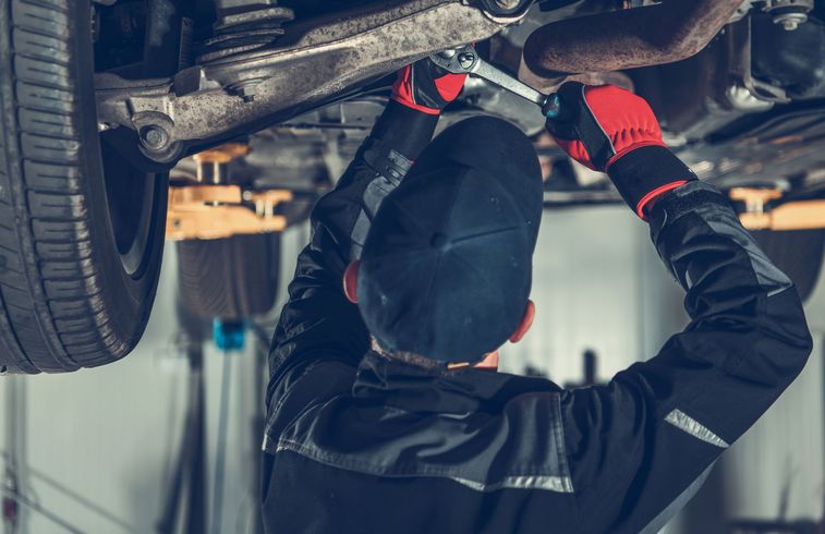 Image of an automotive technician repairing a suspension