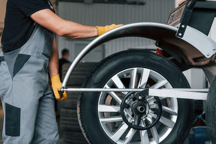 Image of a tire rotation being performed by an automotive technician