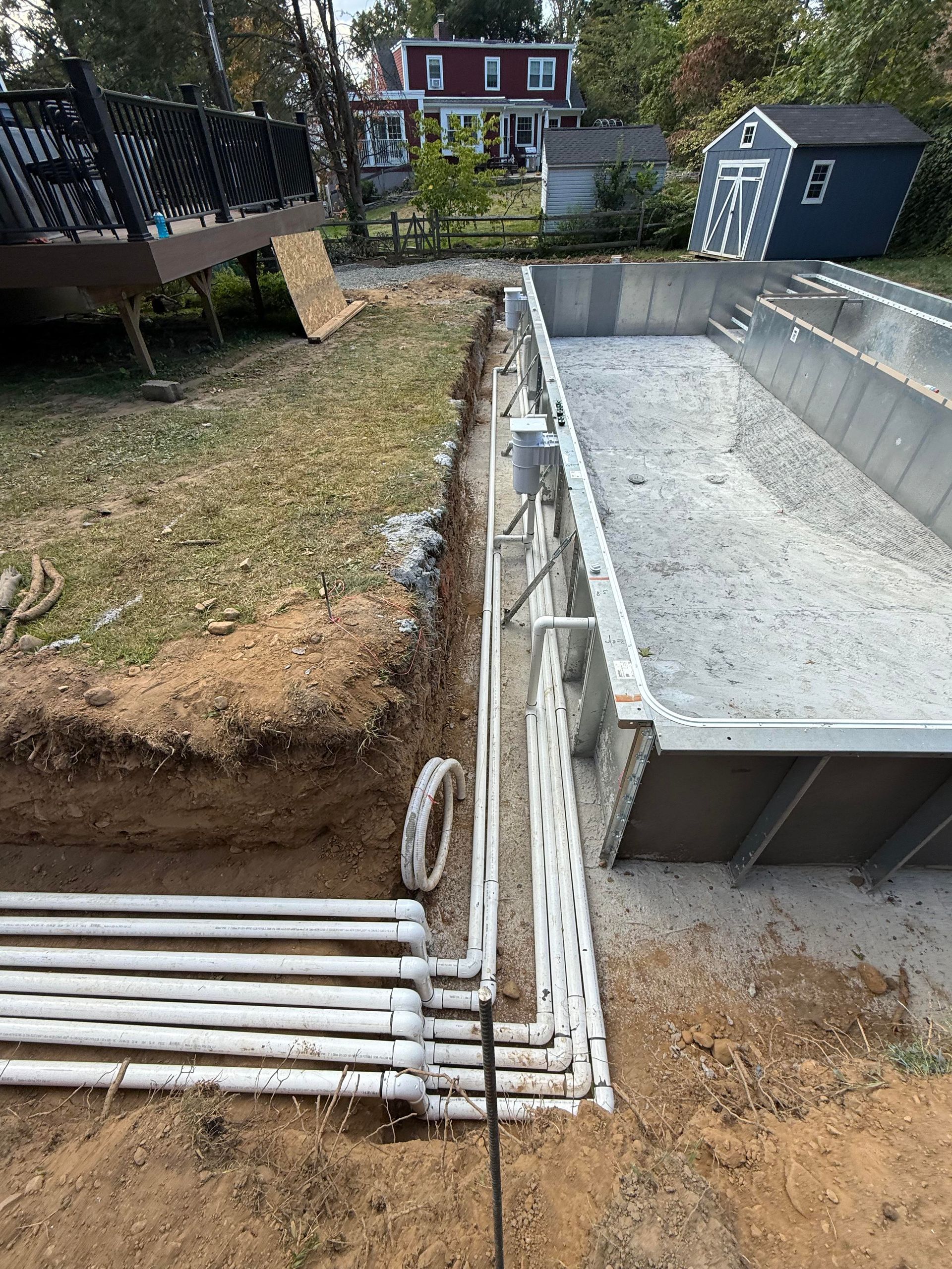 A man is measuring a swimming pool with a tape measure